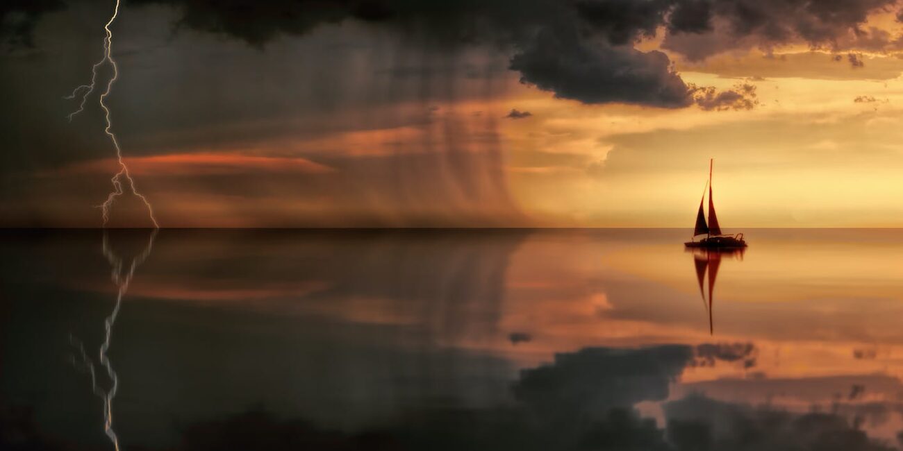 silhouette photography of boat on water during sunset